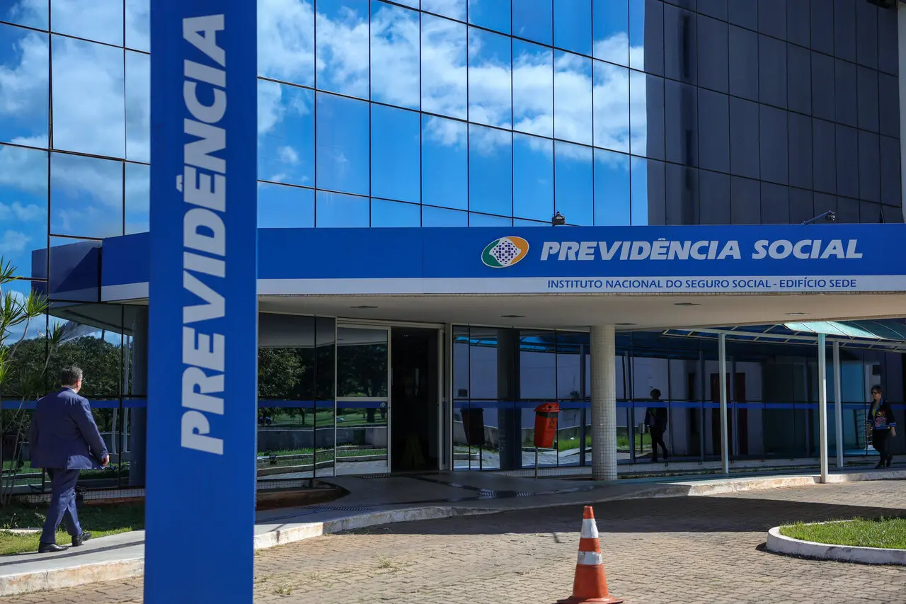Fachada de um prédio com dizer vertical em fundo azul e letras brancas 