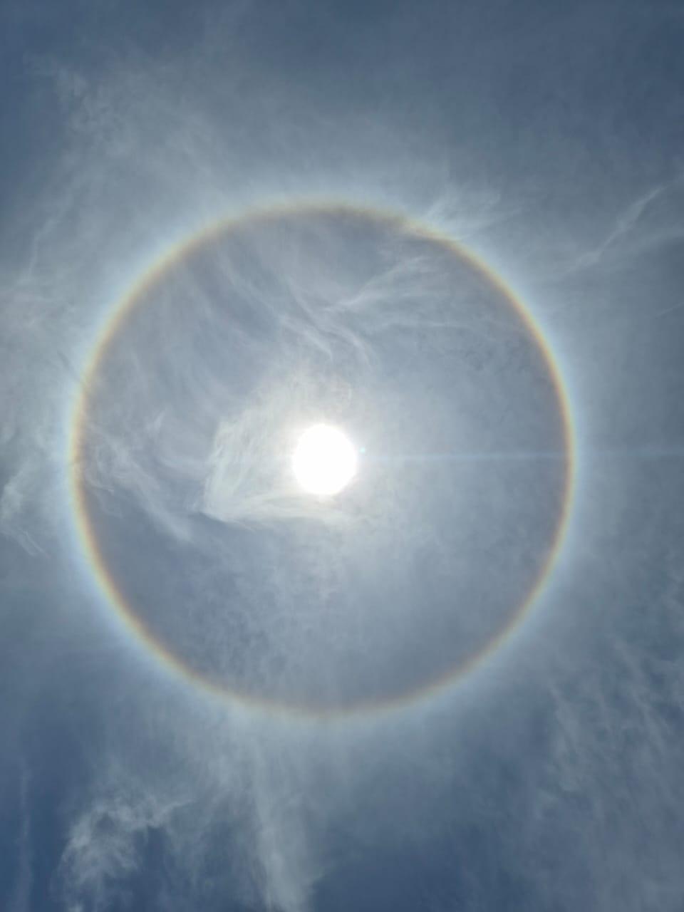 Círculo colorido similar ao arco-íris ao redor do sol.