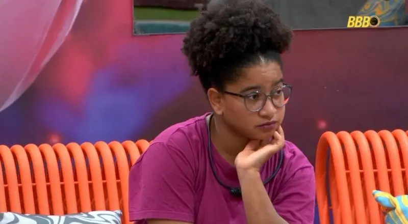 Milena, participante do BBB 26, em pose de preocupação. ela está sentada com a mão no queixo.