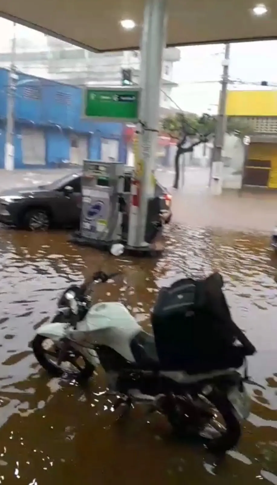 Foto de um posto de gasolina coberto com água barrenta de chuva no Crato.