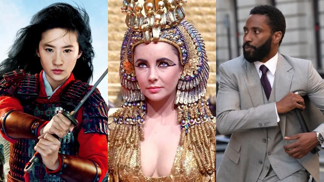 Montagem de personagens de grandes produções cinematográficas, destacando a guerreira Mulan com sua espada, Cleópatra em seu traje dourado majestoso e o protagonista de Tenet em um terno cinza elegante. A composição contrasta diferentes épocas e estilos visuais, unindo o épico histórico e o moderno em uma apresentação vibrante de figurinos icônicos.