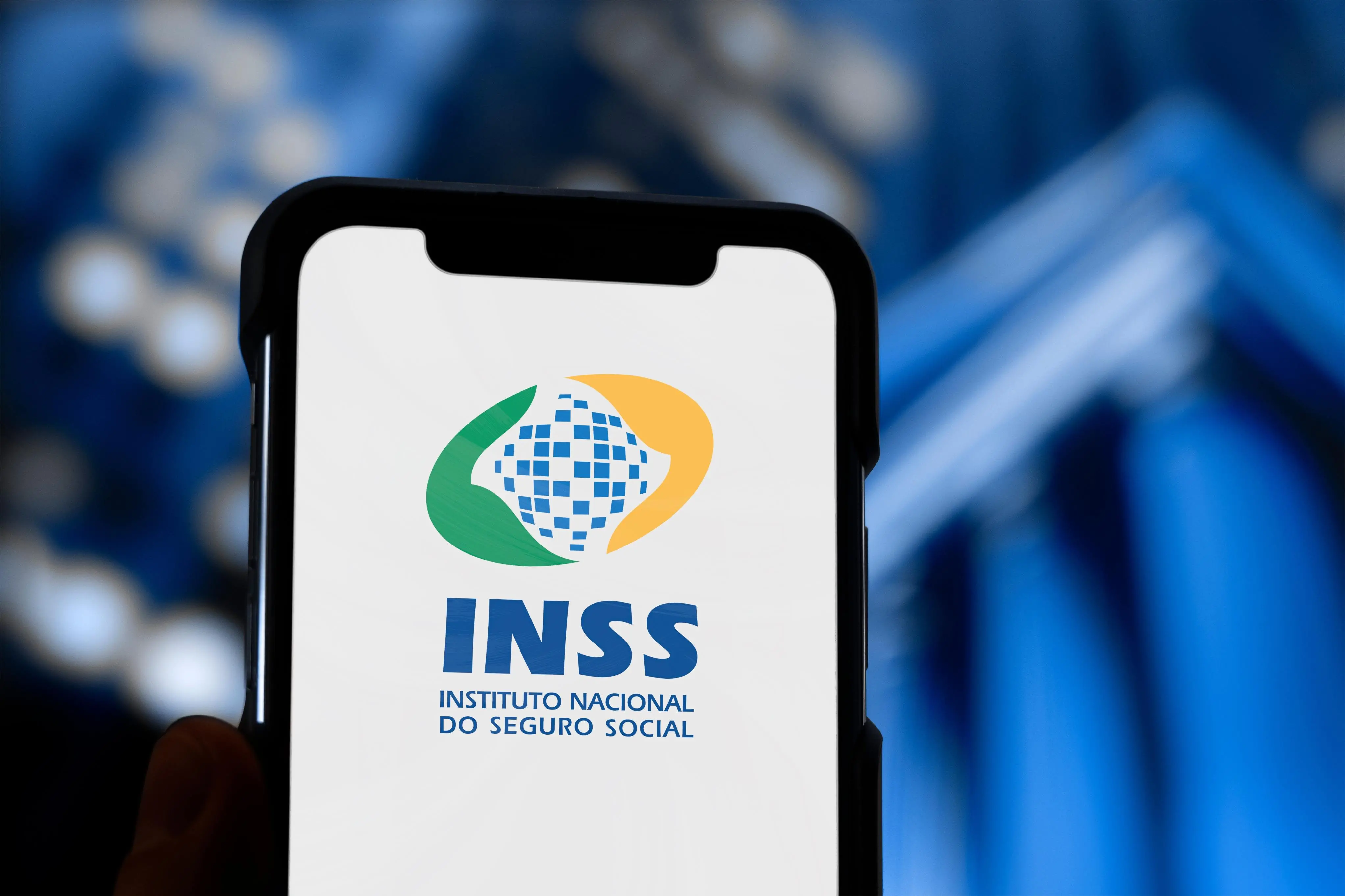Imagem de um celular com a logo do INSS, governo federal antecipa pagamento de 13º de aposentados e pensionistas do INSS.