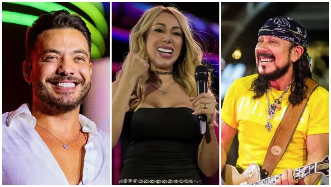 Vista aérea noturna de um grande espaço de eventos ao ar livre, com palco iluminado ao fundo, estruturas cenográficas coloridas e projeções de luz no chão, além de fileiras organizadas de mesas e áreas de circulação.