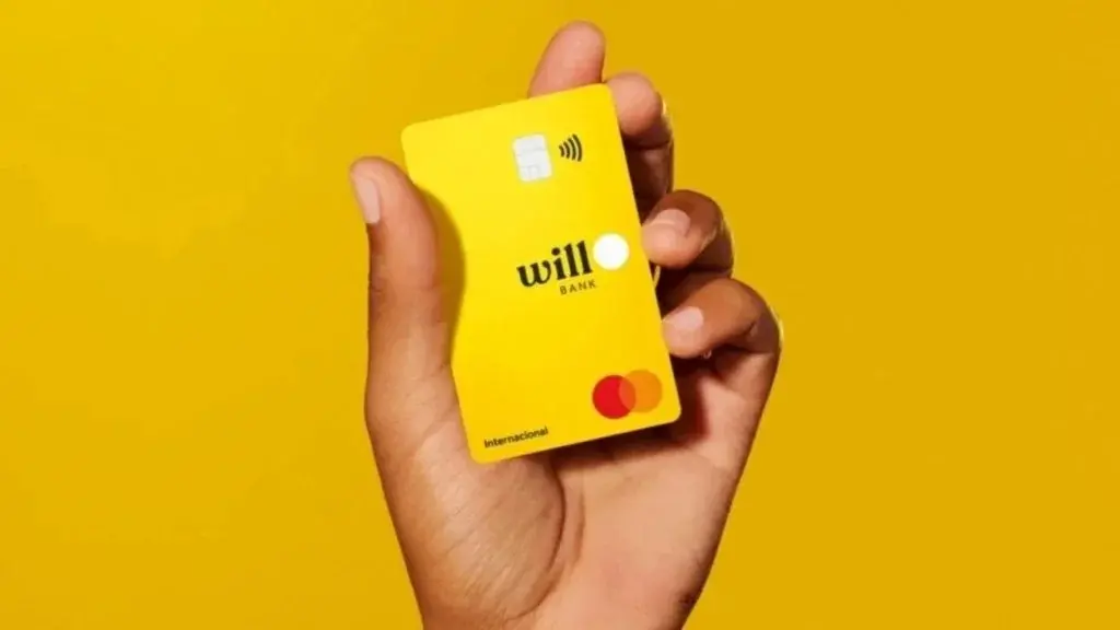 foto de mão de pessoa segurando um cartão do Will Bank.