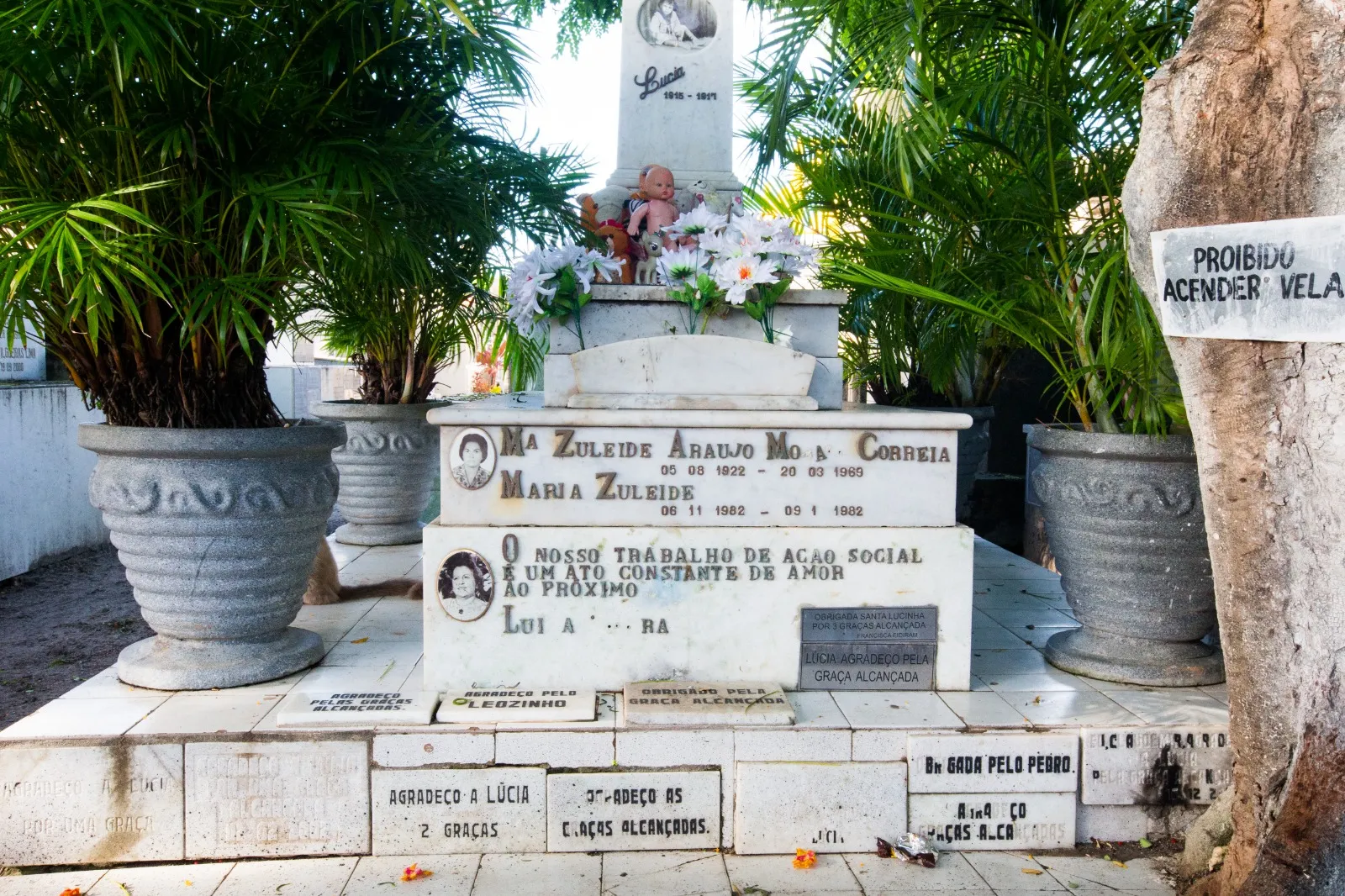 Fiéis agradecem graças alcançadas em placas instaladas na sepultura da menina.