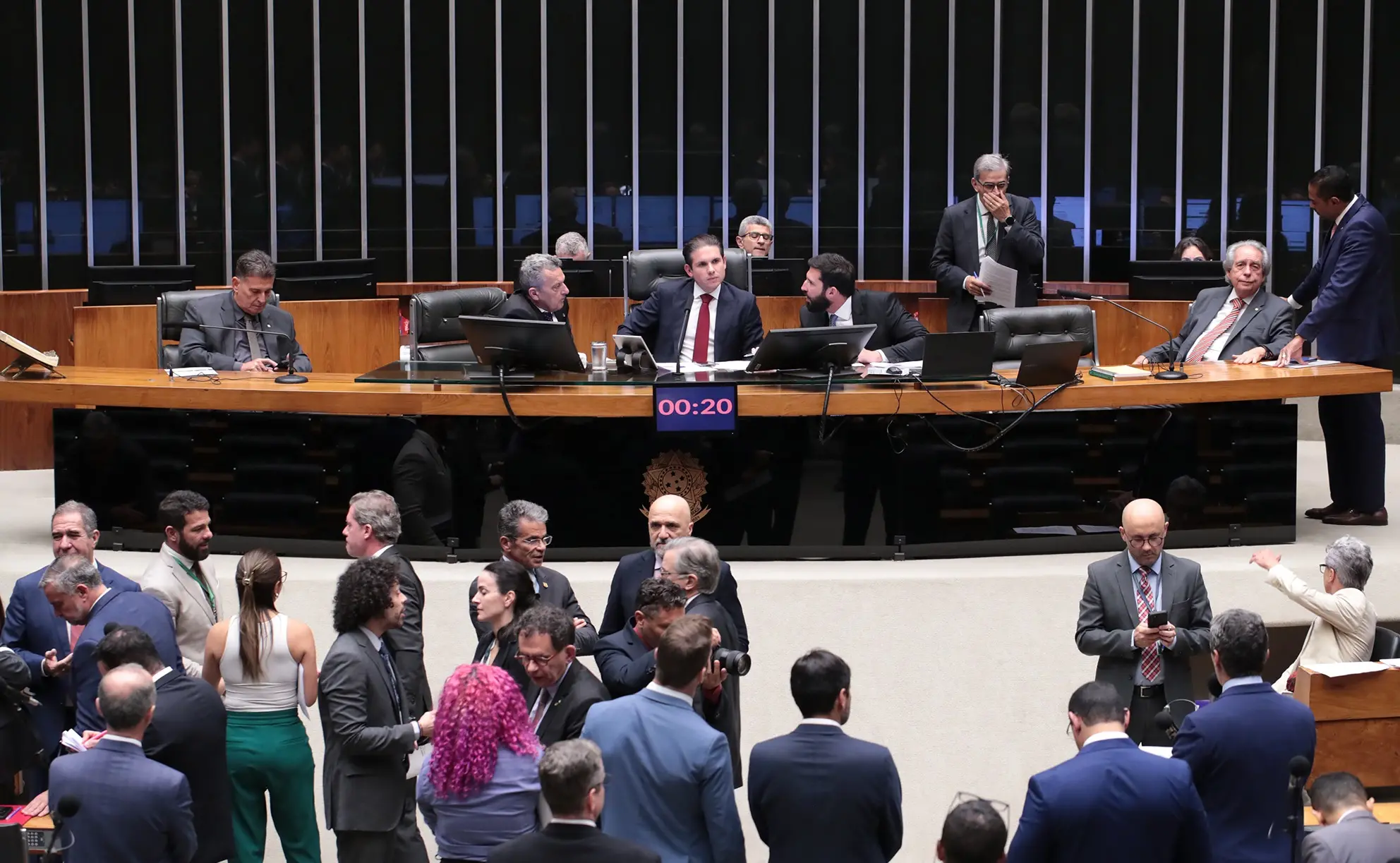 Imagem do Plenário da Câmara dos Deputados com parlamentares conversando. Na Mesa, o presidente da Casa, Hugo Motta.