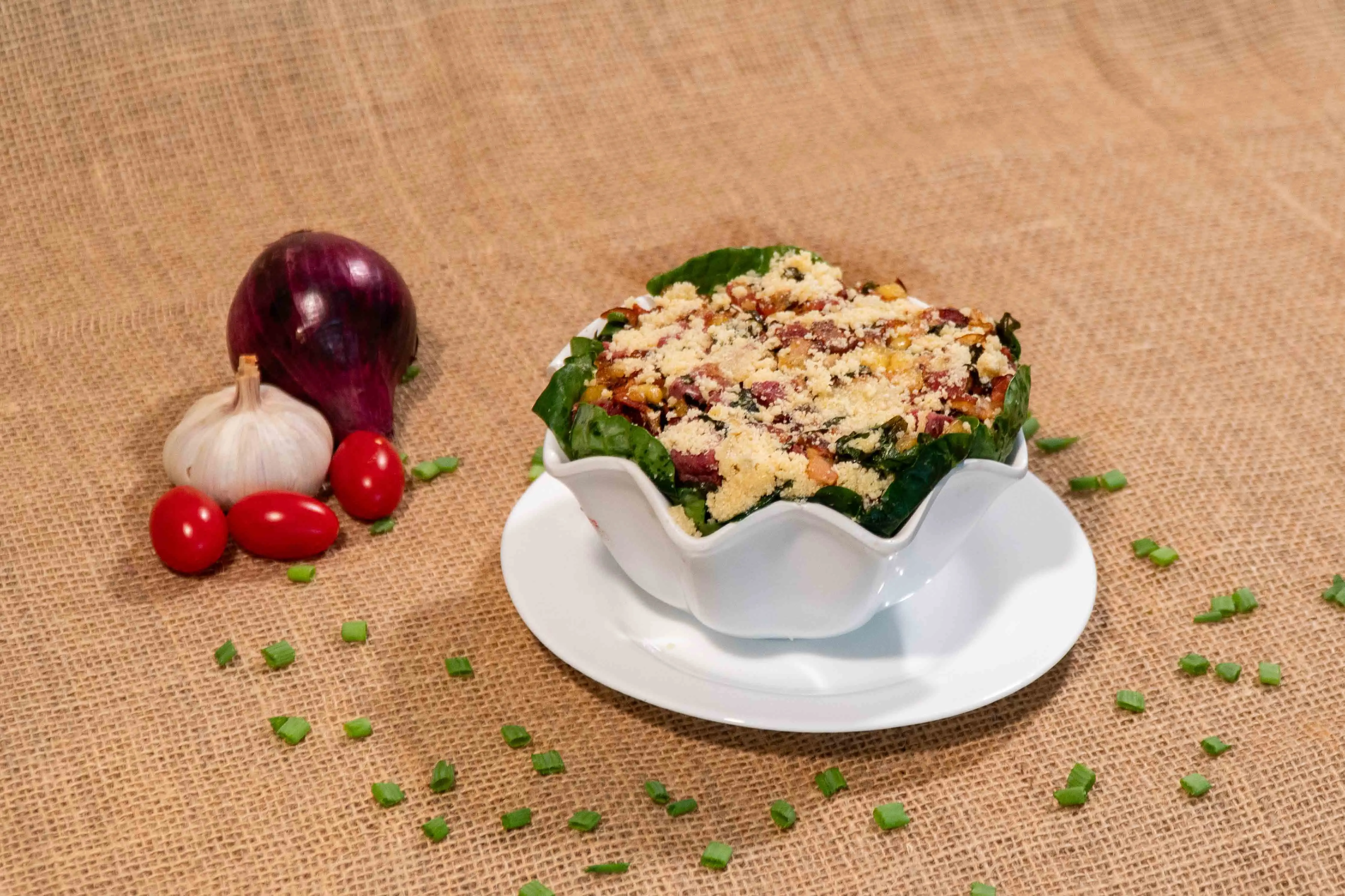 Carne de charque acebolada servida sobre cama generosa de couve refogada.