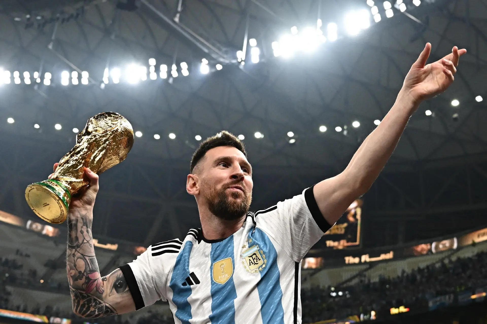 Lionel Messi comemora mostrando a taça de campeão da Copa do Mundo