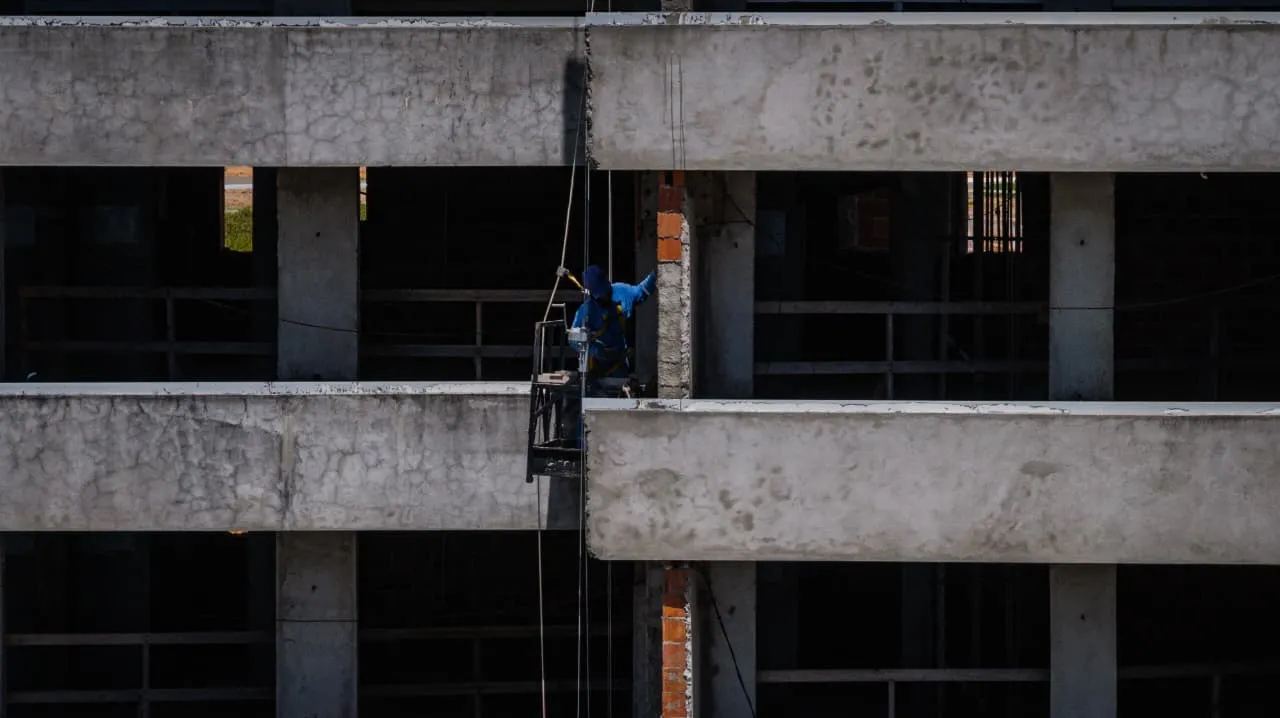 É possível ver uma pequena movimentação de colaboradores trabalhando na obra do empreendimento.
