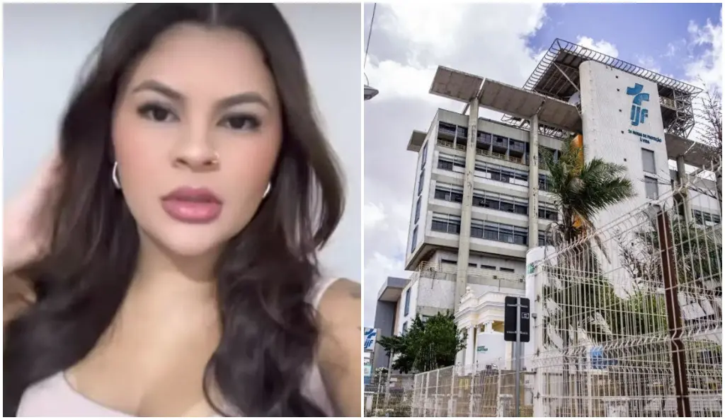 Pessoa em primeiro plano, enquadrada do peito para cima, com cabelos longos e escuros, usando brinco e blusa clara, ao lado de imagem de fachada de prédio institucional com várias janelas, estrutura elevada no topo, logomarca na parede, grades em frente e árvore ao lado sob céu parcialmente nublado.