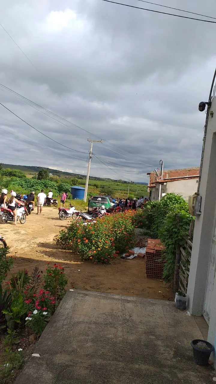 Movimentação de pessoas e motocicletas em rua de terra no bairro Conjunto João Pinto, em Pedra Branca, Ceará, onde uma adolescente foi morta.