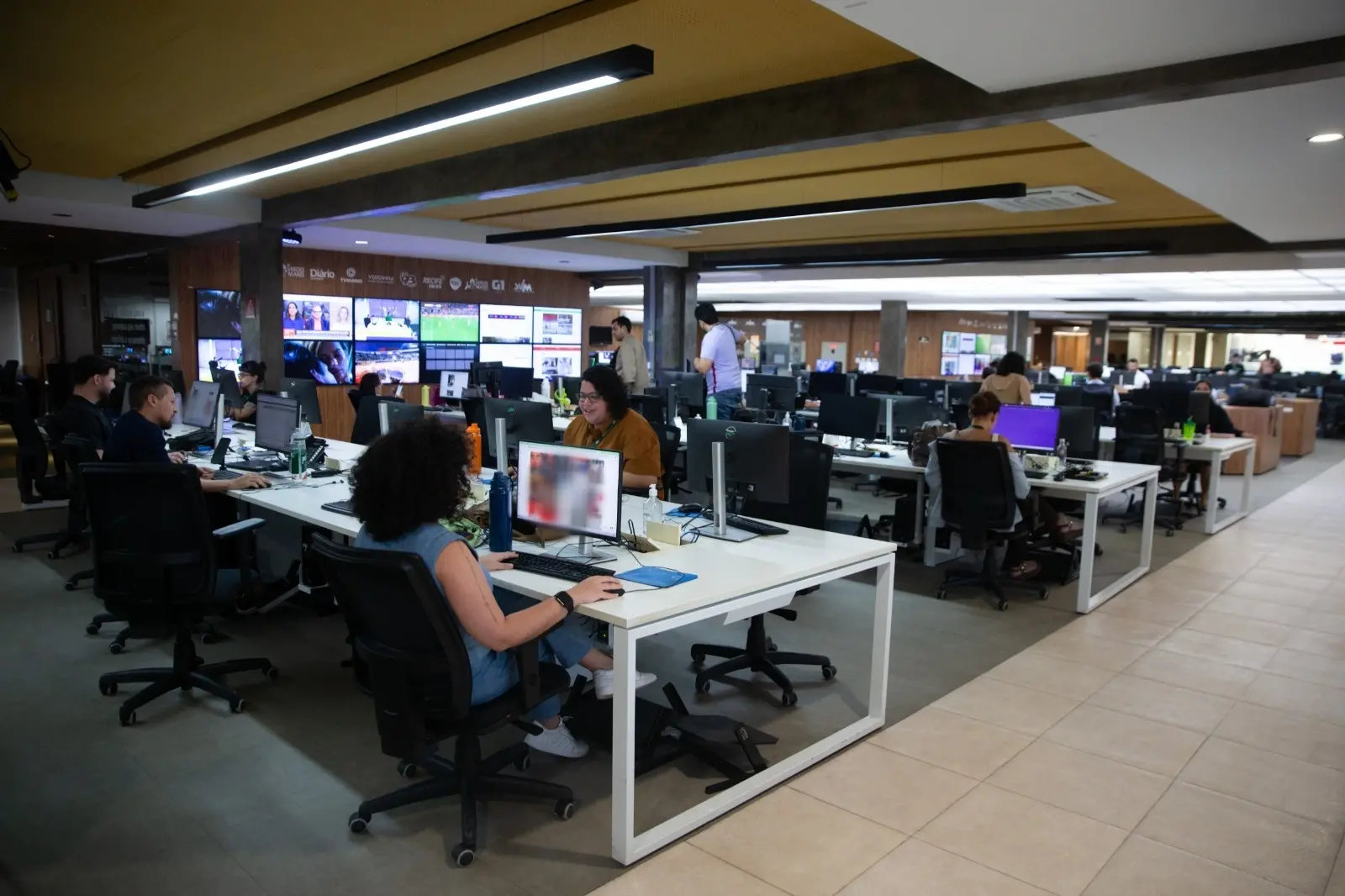 Redação do Diário do Nordeste, com jornalistas sentados mexendo em computadores.
