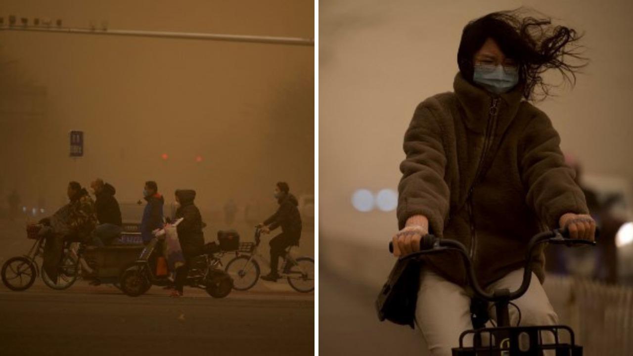Pessoas são vistas no distrito comercial central de Pequim durante uma tempestade de areia