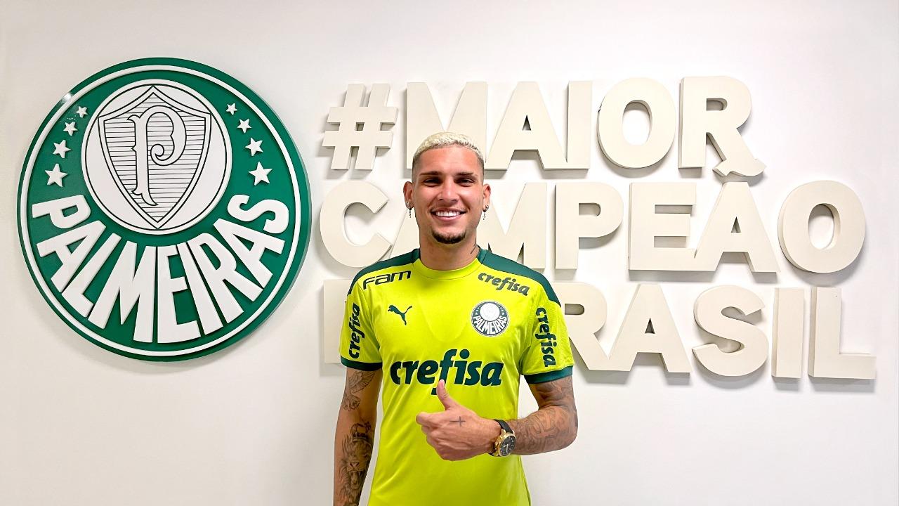 Rafael Navarro posa para foto na frente do escudo do Palmeiras