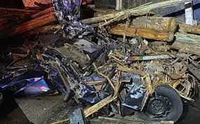 Carro esmagado por tora de eucalipto