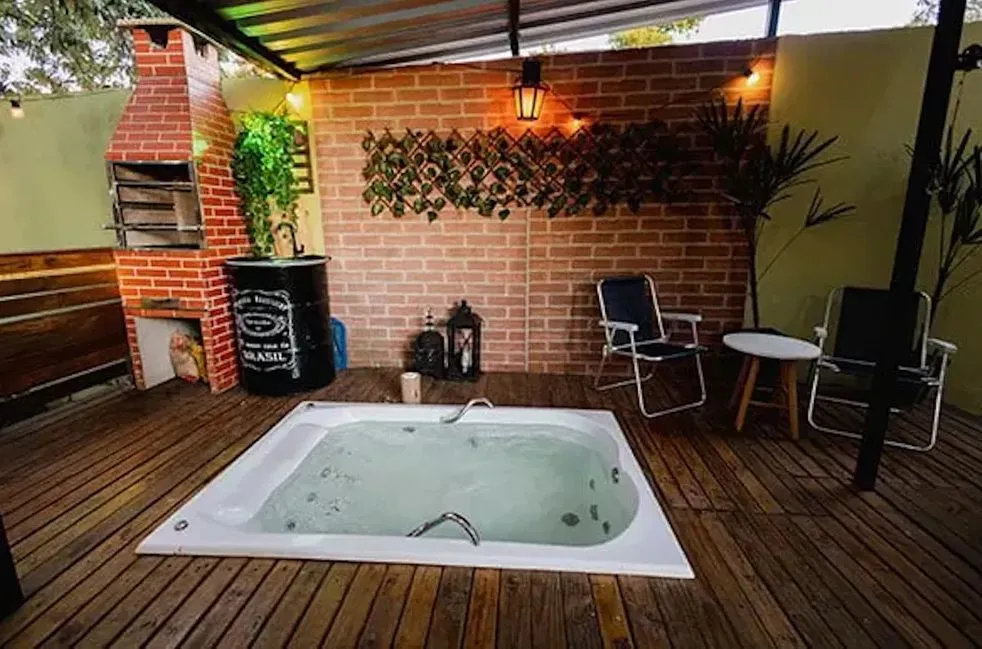 A área externa ainda possui banheira de hidromassagem com churrasqueira