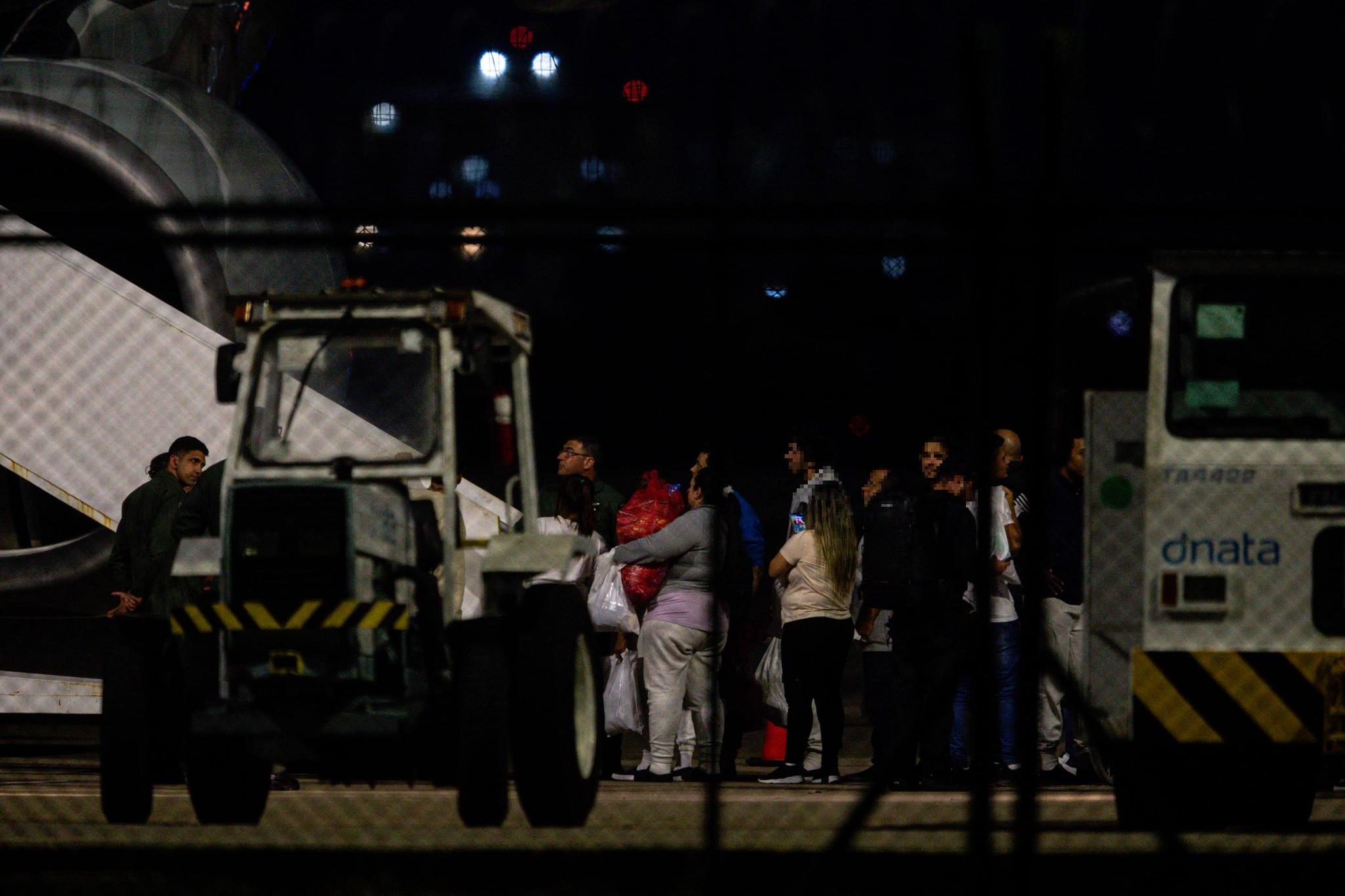 Pessoas repatriadas aguardam para subir no avião da FAB