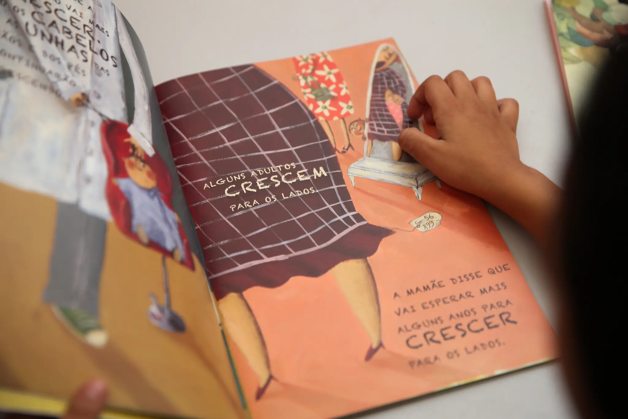 Criança lendo livro infantil