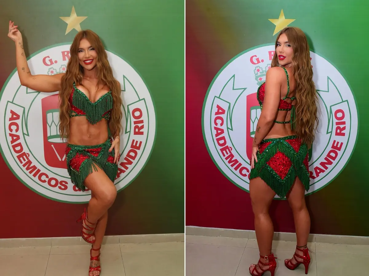 Virginia Fonseca posa em frente ao logo da Grande Rio com fantasia verde e vermelha de Rainha de Bateria.