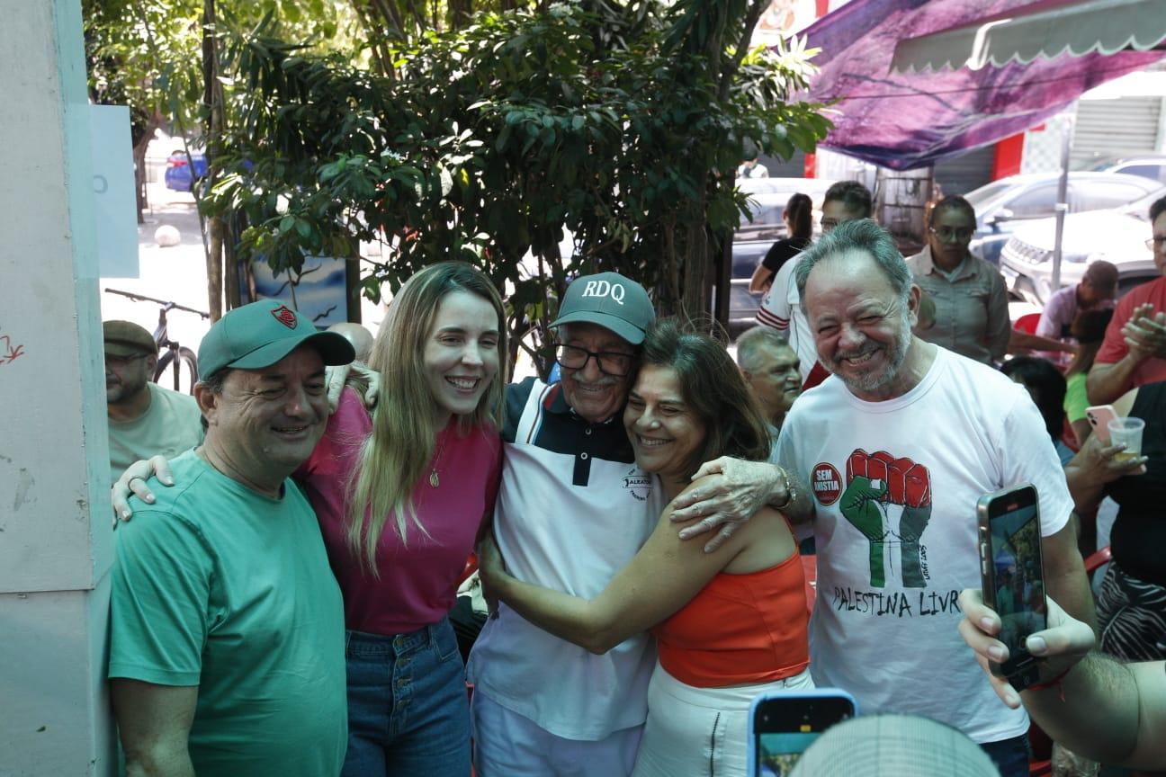 Foto de Raimundo do Queijo abraçado a pessoas. Duas delas são a vice-governadora Jade Romero e o deputado Acrísio Sena.
