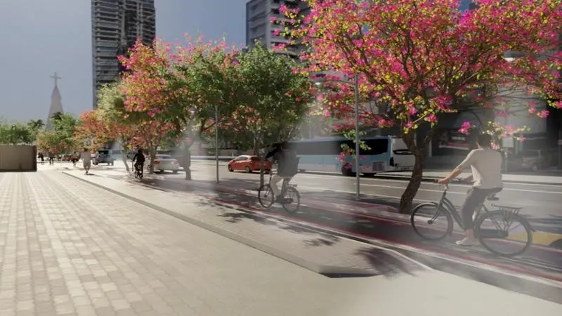 Projeto de ciclovia arborizada na Avenida Dom Luís, em Fortaleza, separada da via com carros e ônibus por um canteiro central com árvores floridas de copa rosa.