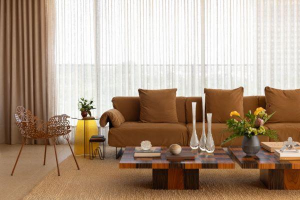 Acompanhando as características do sofá, o pufe cumpre o seu papel principal como a parte prática do apoio de uma mesa de centro