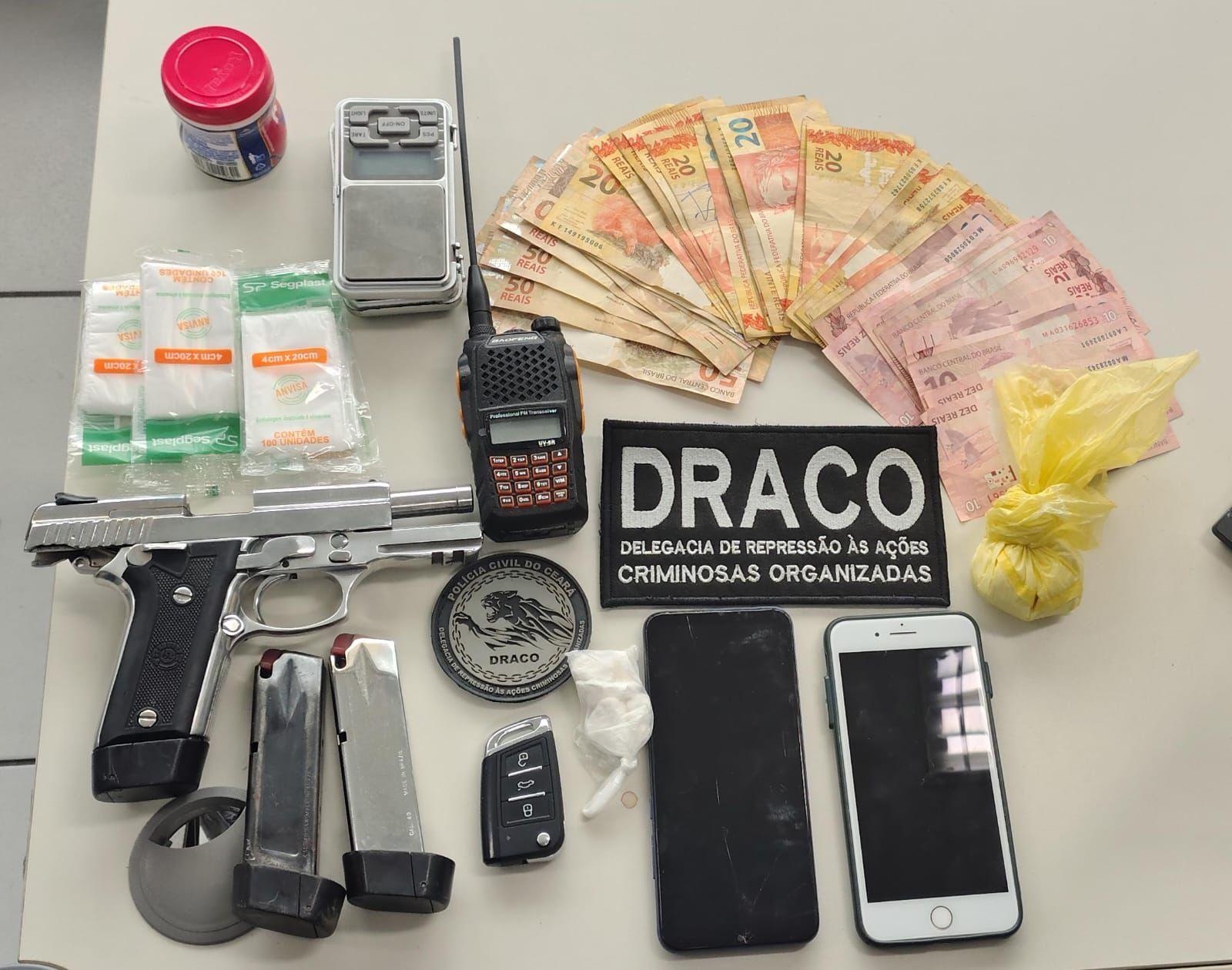 A foto mostra uma arma de fogo, carregadores, drogas, dinheiro e outros objetos apreendidos com suspeitos em operação da Polícia Civil do Ceará.