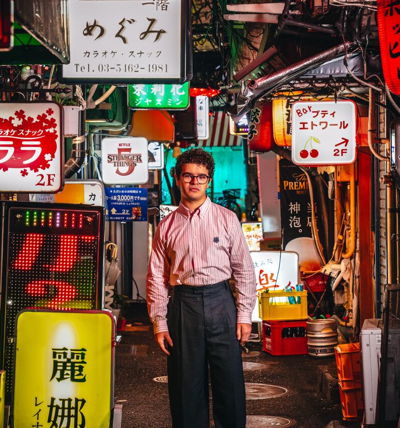 Gaten Matarazzo em rua japonesa para foto de divulgação da quinta temporada de Stranger Things.