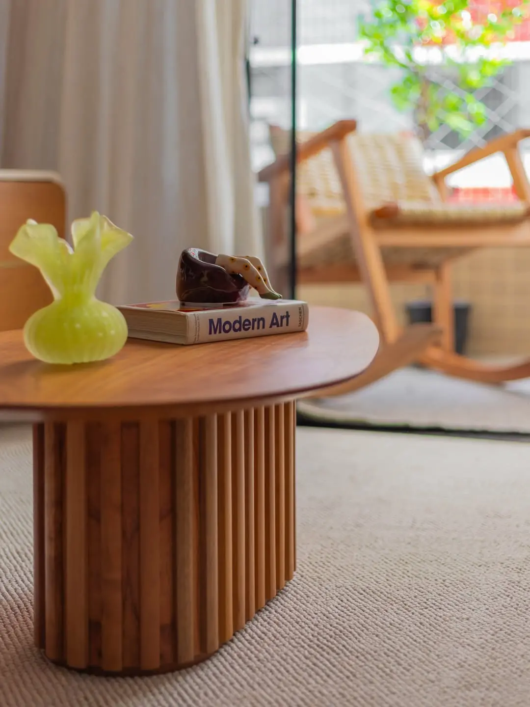 Mesa com livro e esculturas.