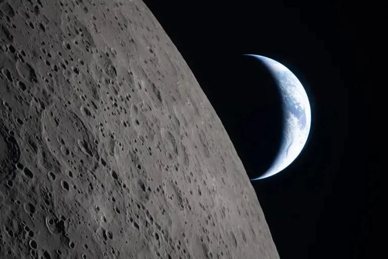 Nesta foto que mostra uma Terra crescente se pondo na borda lunar, a parte escura do planeta está de noite, enquanto a Austrália e Oceania estão iluminadas pelo sol.