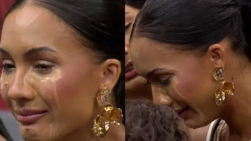 Imagem de uma mulher celebridade com lágrimas nos olhos, usando brincos dourados grandes e expressando emoções intensas em um evento.